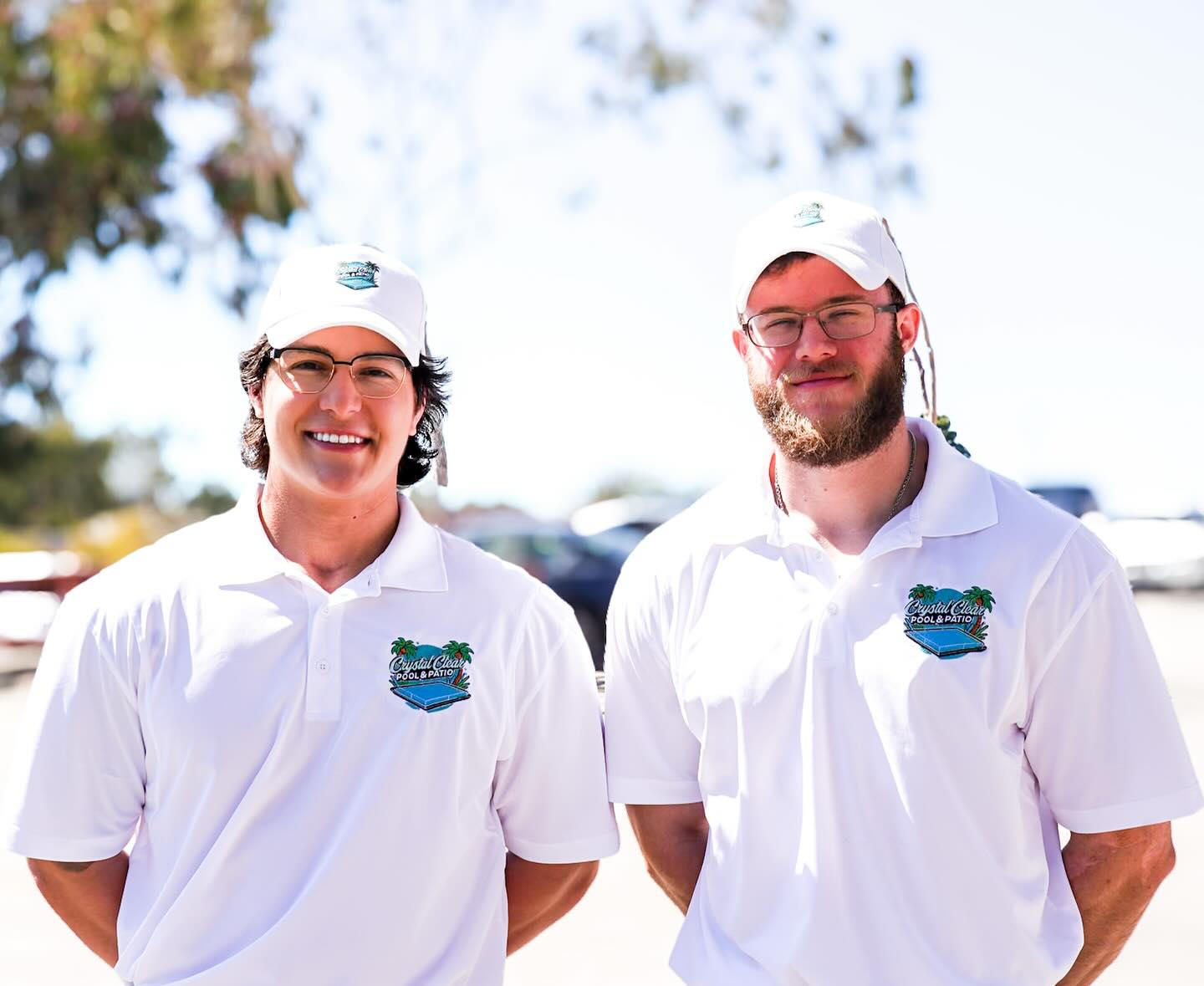 Destin Tirado (left) and Tim O’Maley (right), owners of Crystal Clear Pool & Patio, in company shirts and caps