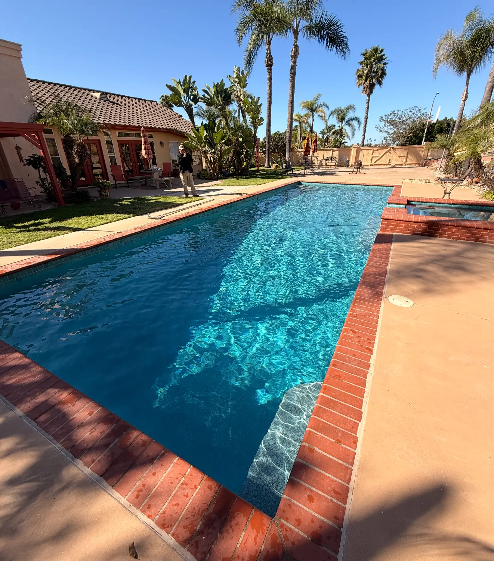 Long rectangular pool with brick coping